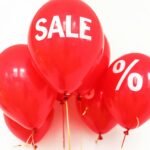 Bright red balloons with 'SALE' and '%' symbols, perfect for marketing promotions.